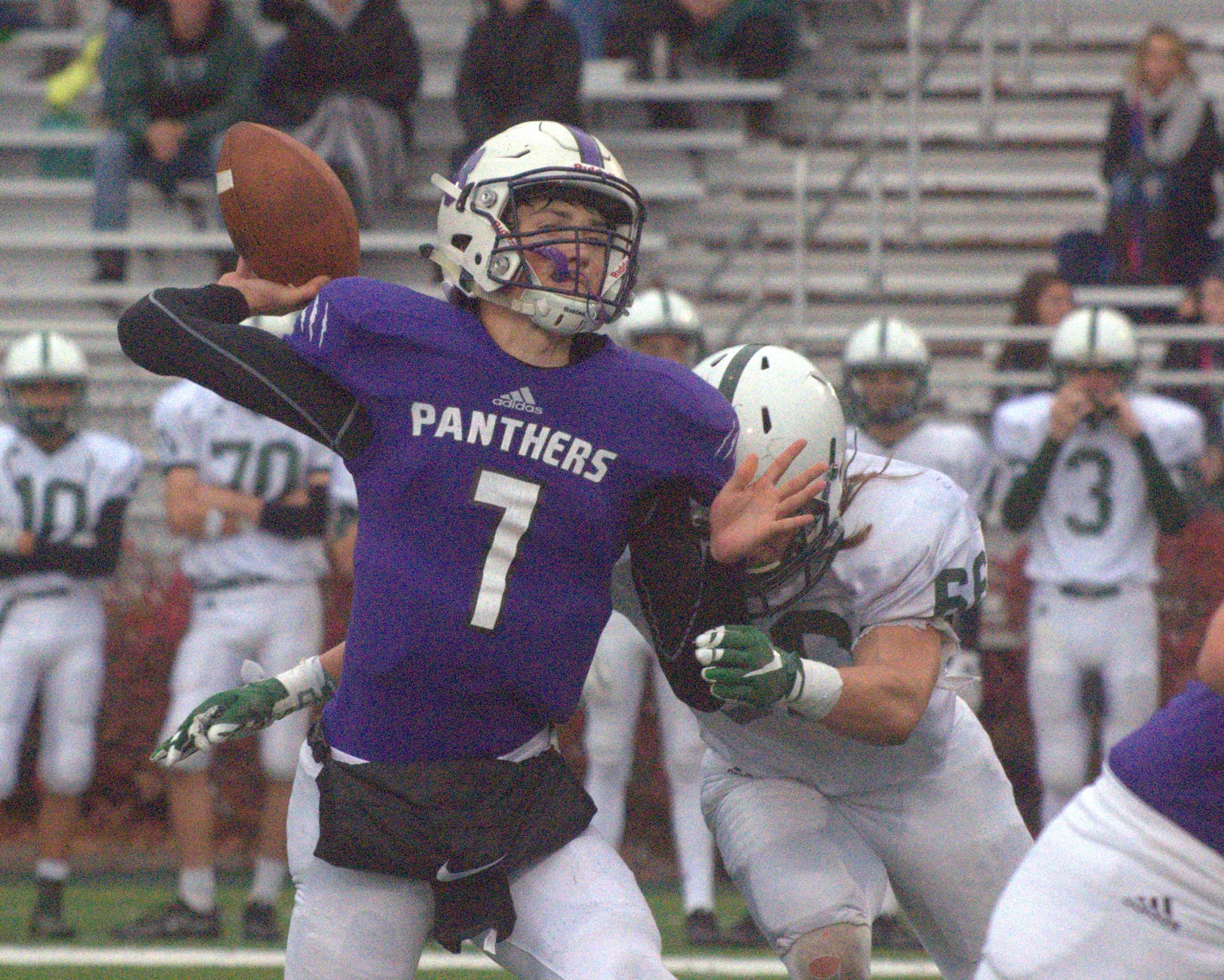 Nashua South's Sean Holland tries to throw a pass before he gets hit by Dover's Dylan Russell.