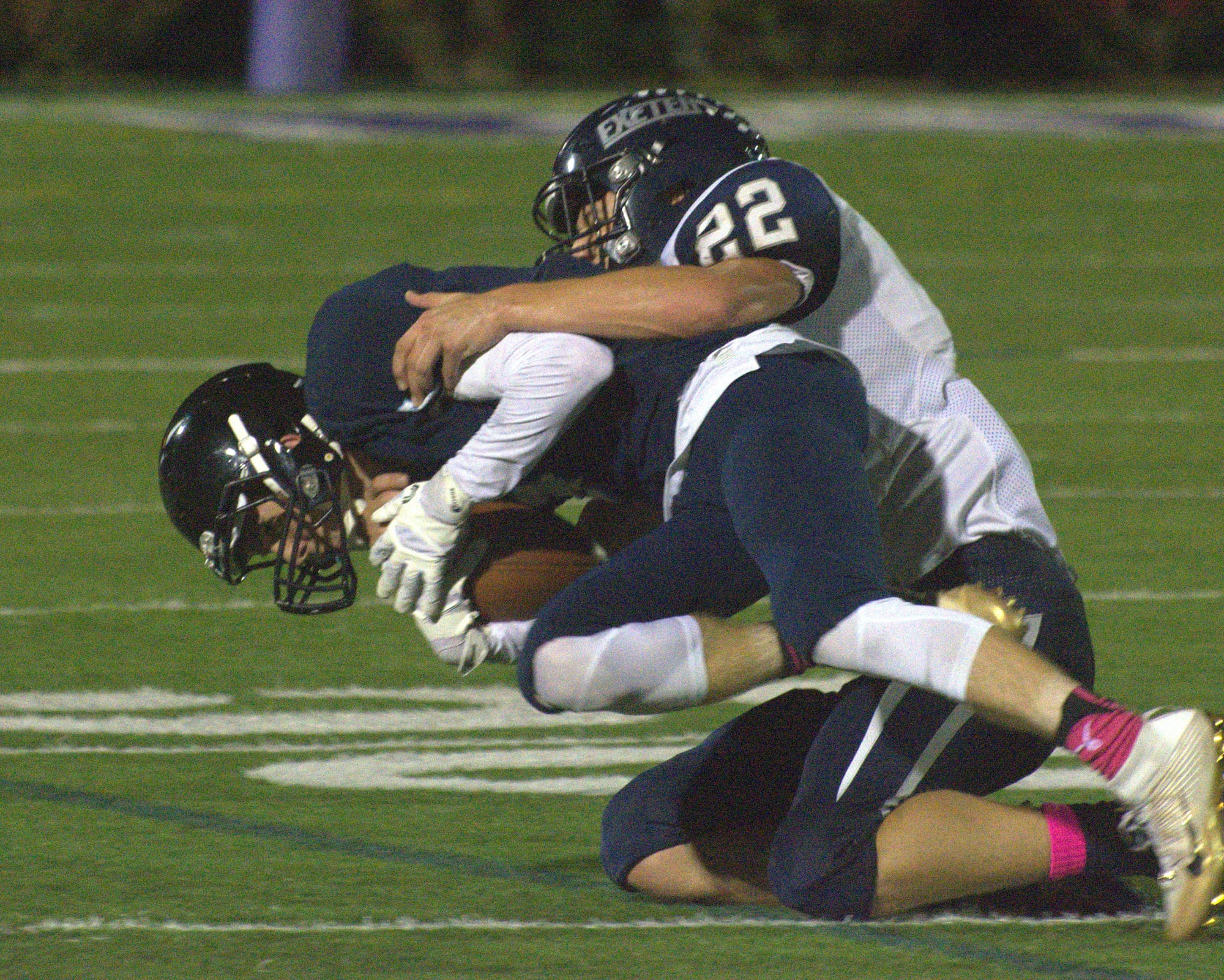 Exeter's Ben Palmer tackles Nashua North's Austin Ouellette.