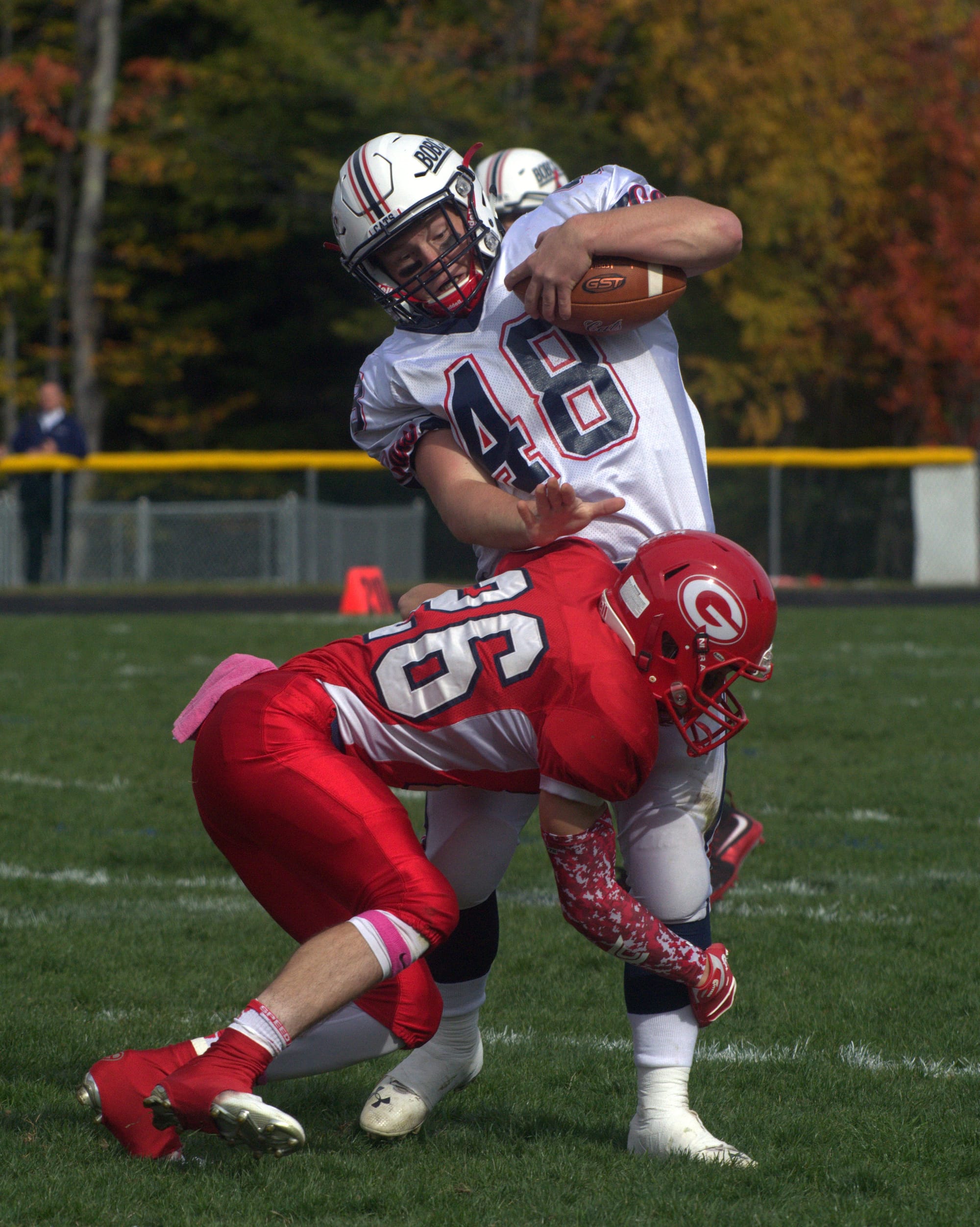 John Stark's Manny Biskaduros wraps up Plymouth's Garrett Macomber.