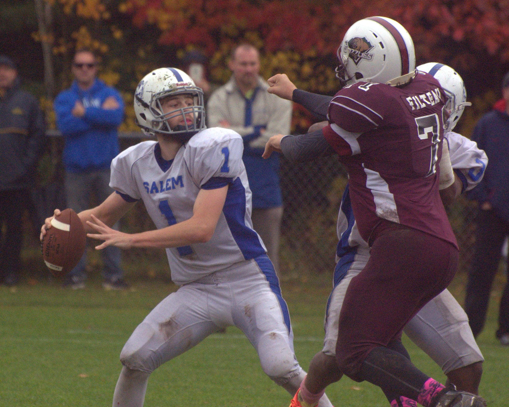 Salem's Matt Soldano looks for a receiver as Goffstown's Christian Filteau applies pressure.