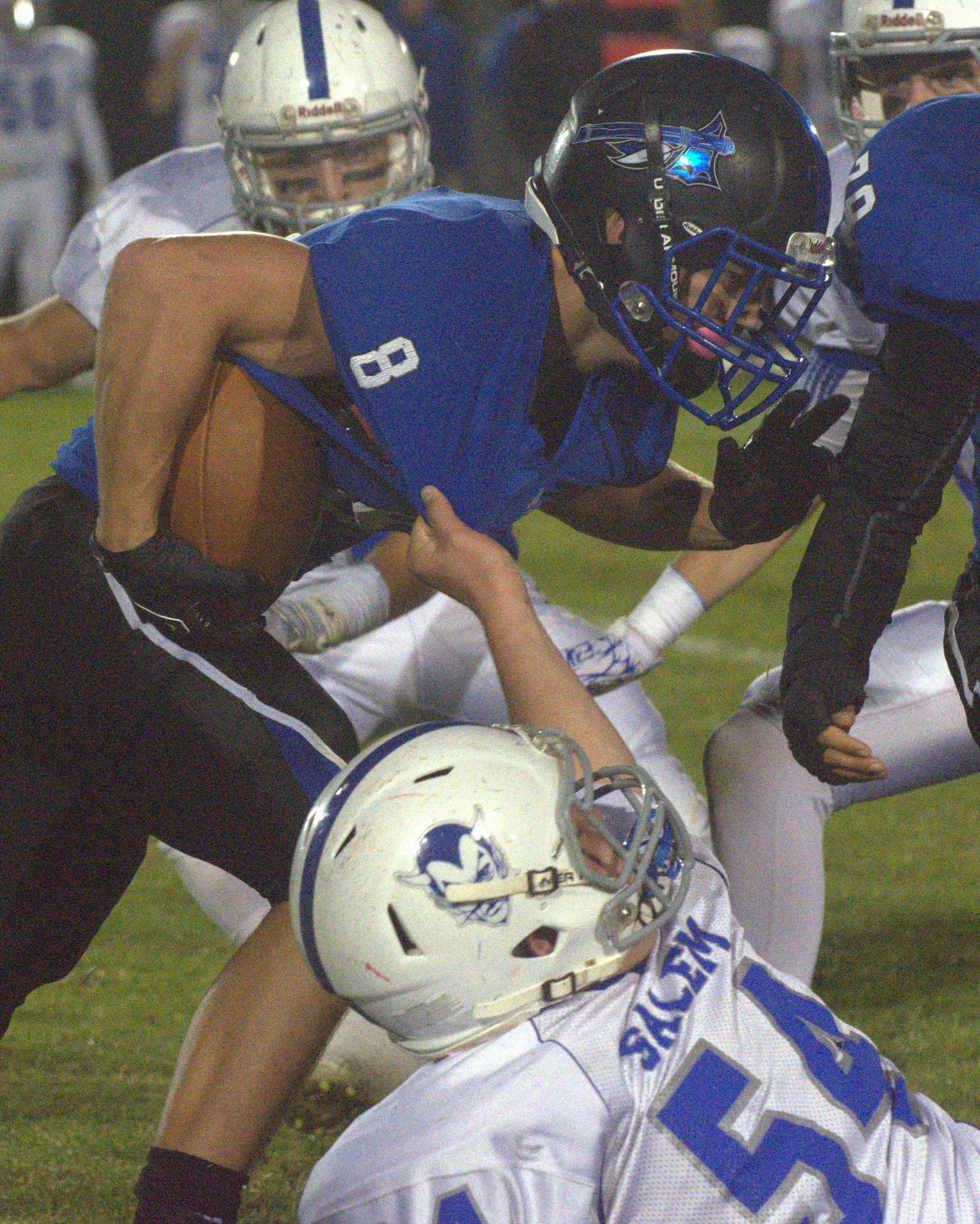 Salem's Jacob Dumont tries to bring down Merrimack's Joe Eichman.