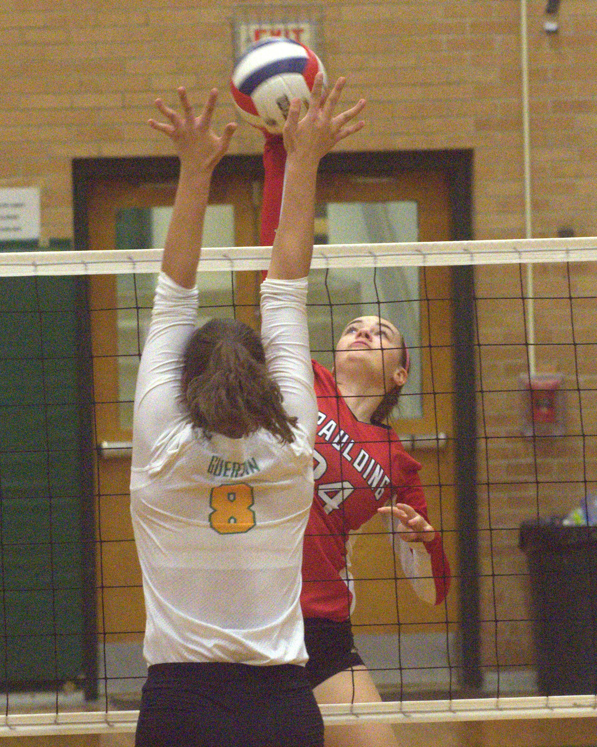 Spaulding's Ashley Tanguay tries to hit the ball past Bishop Guertin's Jill Rabasco.