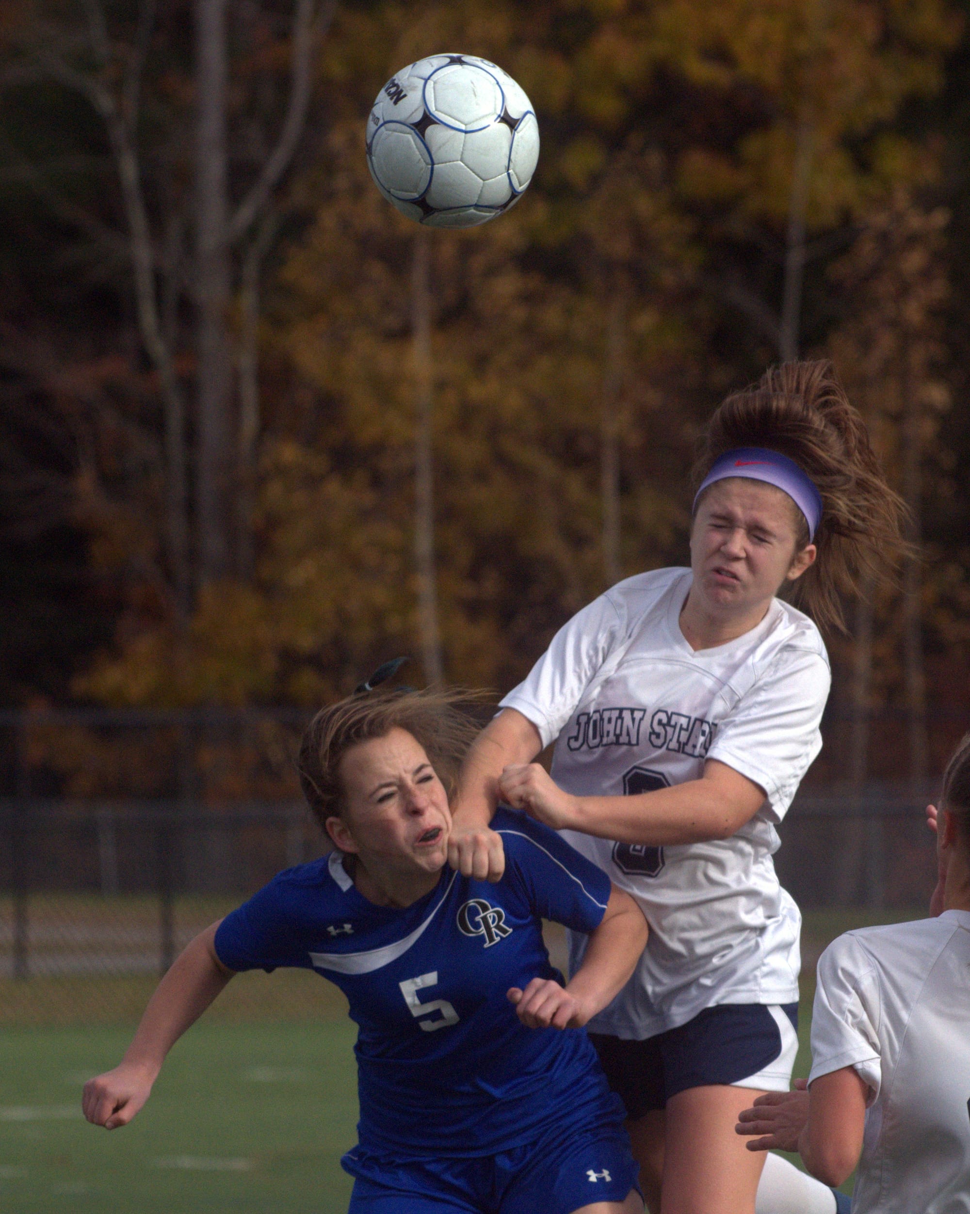 John Stark's Jocelyn Dimond heads the ball over Oyster River's Madison Stringer.