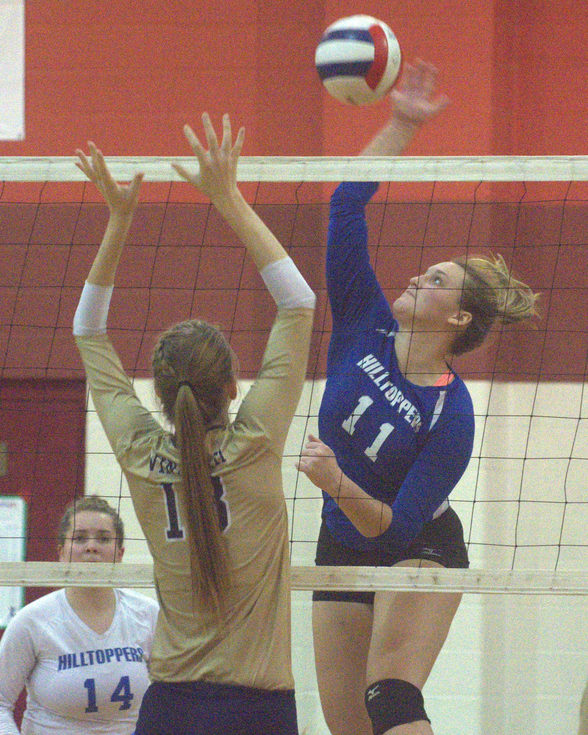 Somersworth's Kaitlyn Lavoie tries to hit over Windham's Emily Frank.