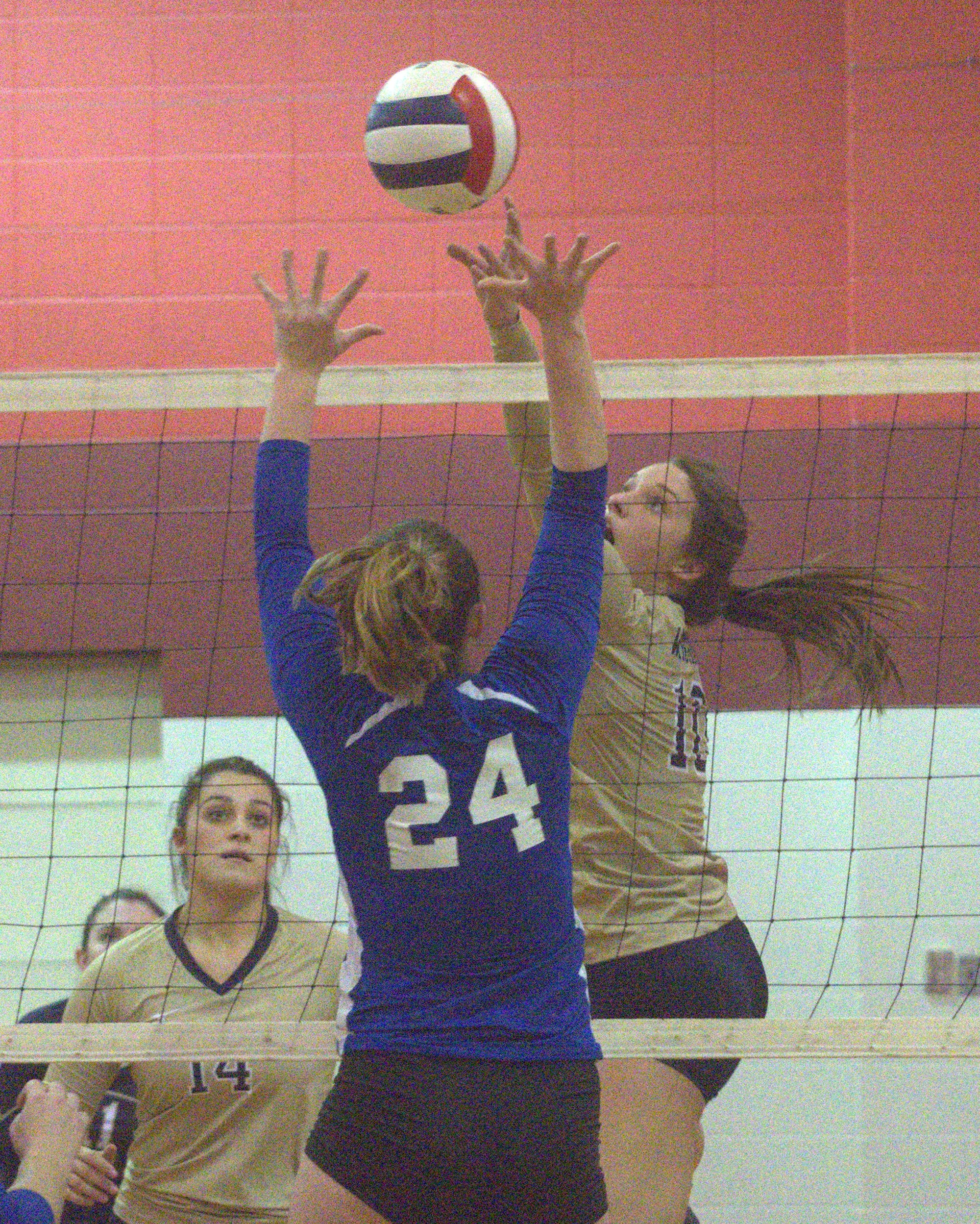 Windham's Taylor Sawyer tips the ball over Somersworth's Hunter Gosselin.