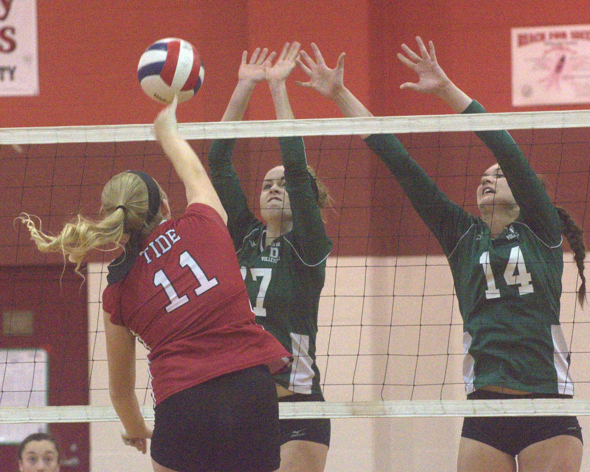 Concord's Lauren Hatch tries to hit past Dover's Sarah Quinn, left, and Mary Zlotosch.