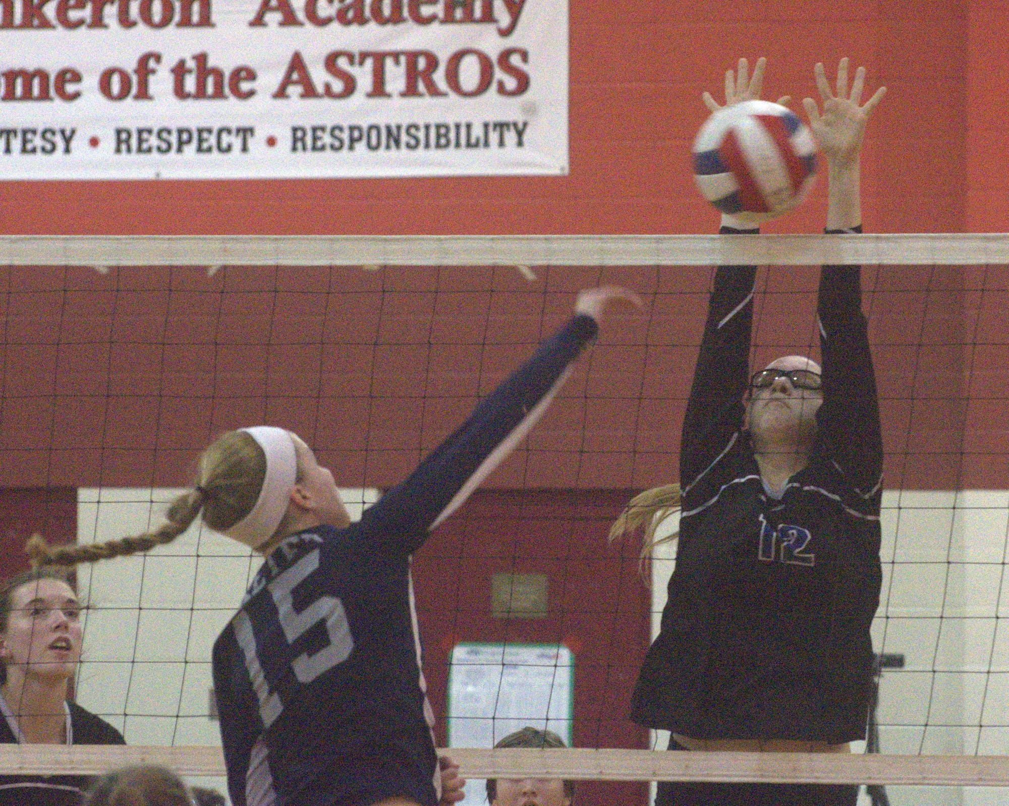 Hollis Brookline's Natalie Cook gets up to block a ball hit by Exeter's Valerie Johnson.
