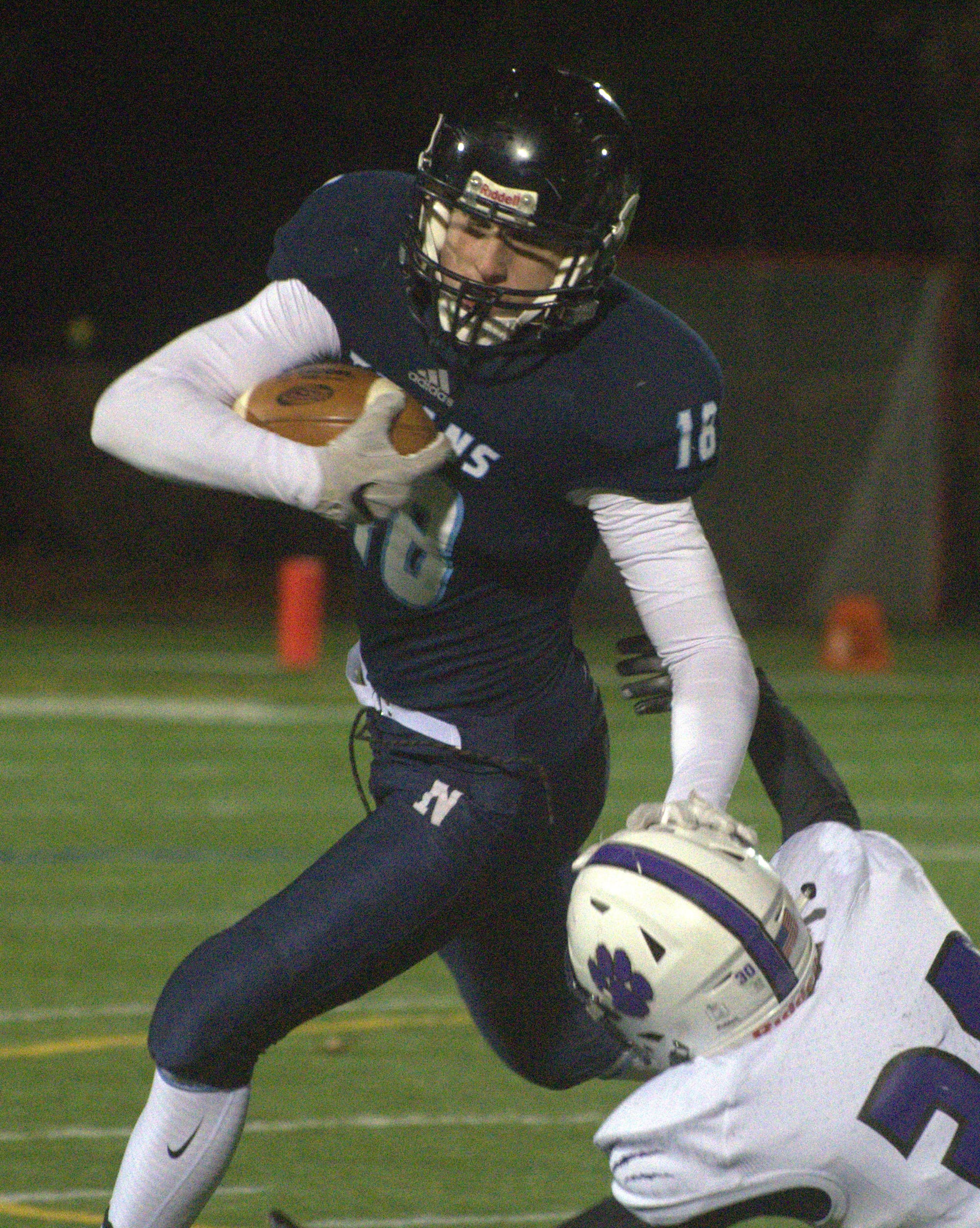 Nashua North's Levi Gosselin tries to fight off a tackle.