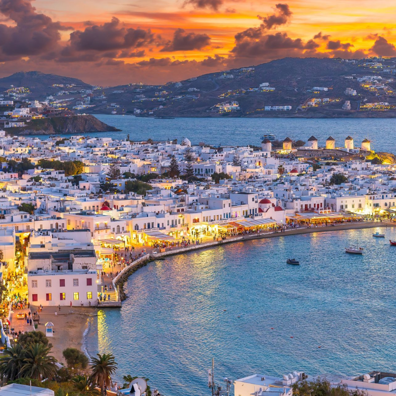 A picture showing a breathtaking sunset view over Chora Town on the Greek island of Mykonos