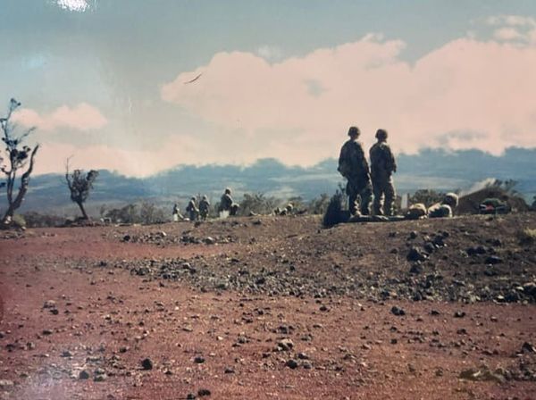 A group of soldiers on a rocky range.