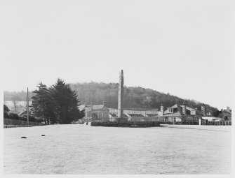 An old black and white photo showing Sueno's Stone from the north - an unusual angle - which emphasises its landscape position on a ridge beneath Cluny Hill where a massive Iron Age hillfort was discovered in 2018
