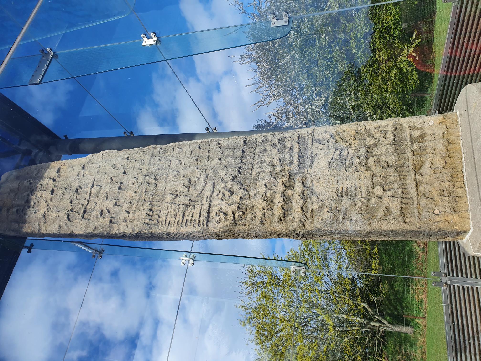 Photograph of the reverse face of Sueno's Stone, showing its sequence of battle scenes. These are badly weathered but the object that Archie Duncan interpreted as a bridge is visible towards the bottom of the stone.