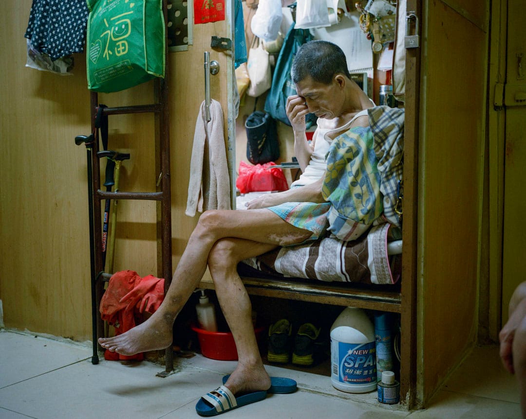 2017年6月，港岛区一个板间房，住客坐在床边看电视。