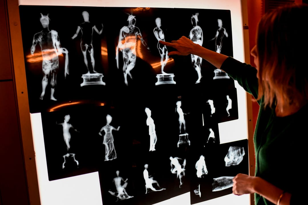 法國國家文物修復中心和國家遺產保護實驗室的修復人員在盧浮宮博物館實驗室分析一枚古董銅像的放射照片。