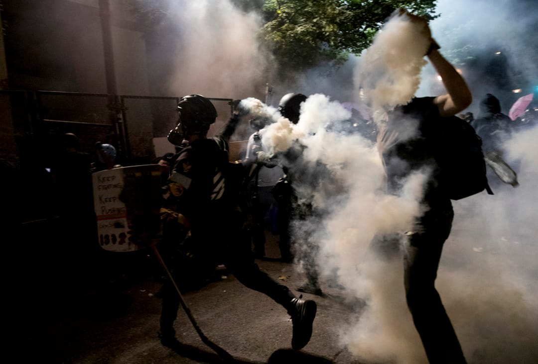 2020年7月29日，波特兰一场游行中，示威者将催泪弹罐拾起向对方扔回。