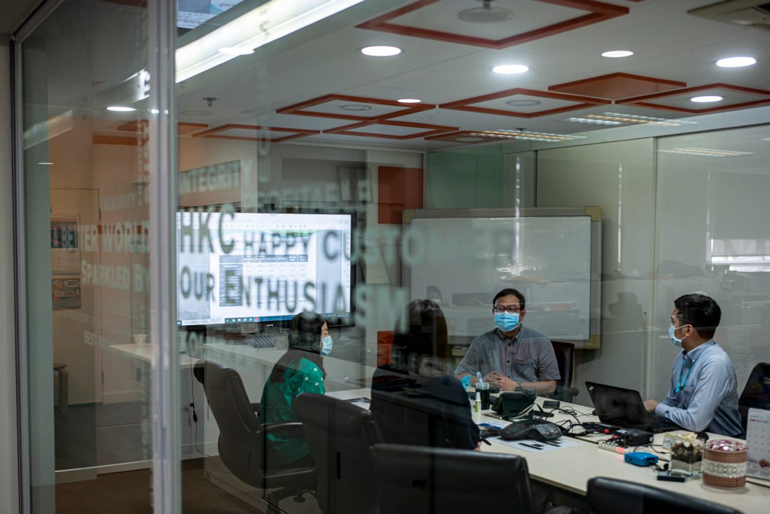 电子厂老闾李锦雄与员工开会。