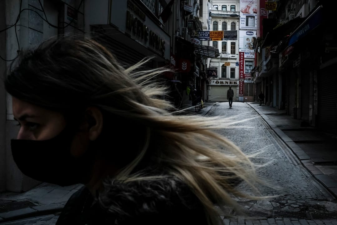 2020年4月1日，土耳其伊斯坦堡爆發新冠疫情期間，一位戴著口罩的女士在空蕩蕩的購物街上行走。