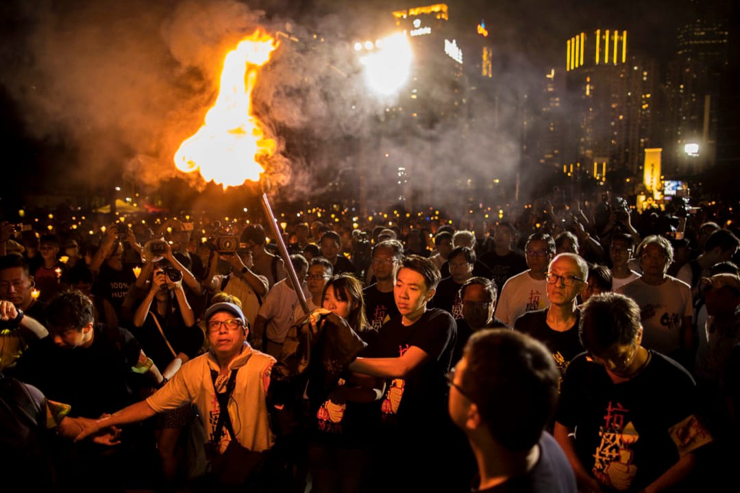 2018年6月4日，「悼六四、抗威權」燭光晚會上，支聯會常委與年青人燃點火炬步向舞台。