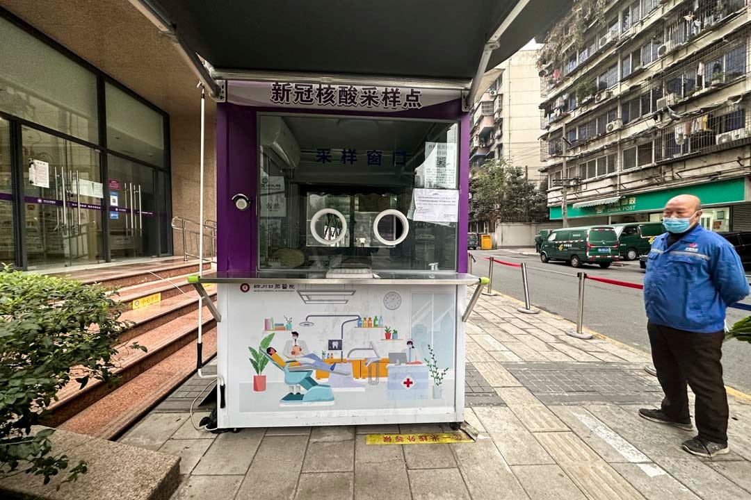 2022年12月8日,中国成都,一名工作人员在拆除一组核酸检测采样站。