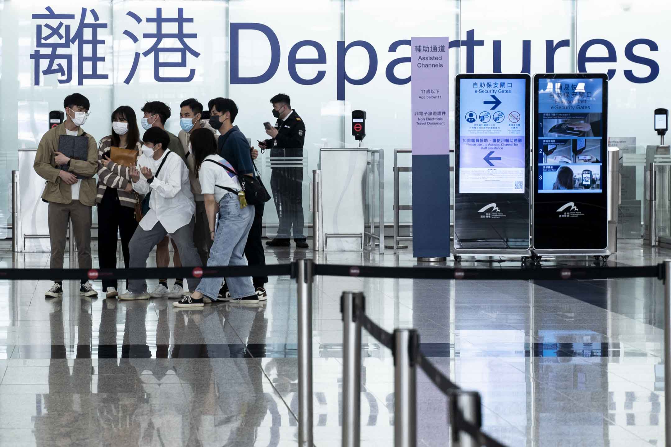 2022年3月30日，香港国际机场的出境大堂，准备离港的人与朋友一起合照留念。