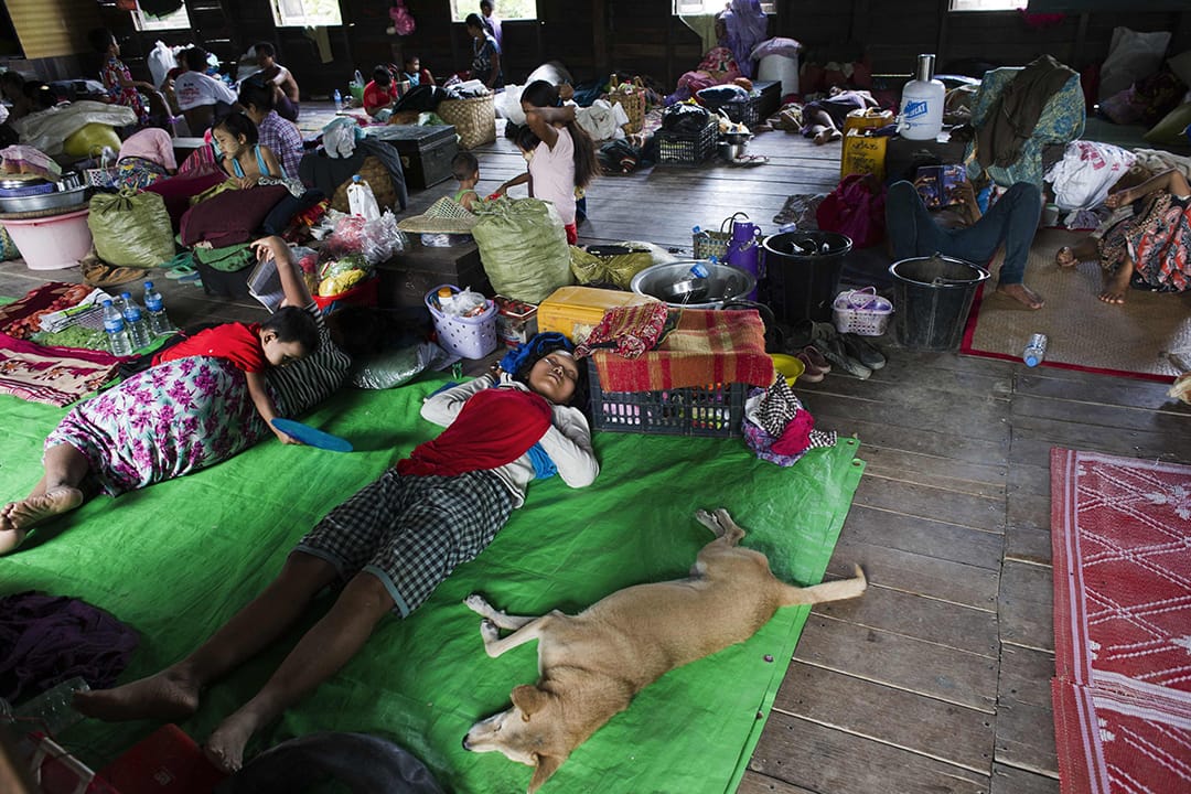 灾民在避难中心避雨。摄:  Ye Aung THU/AFP