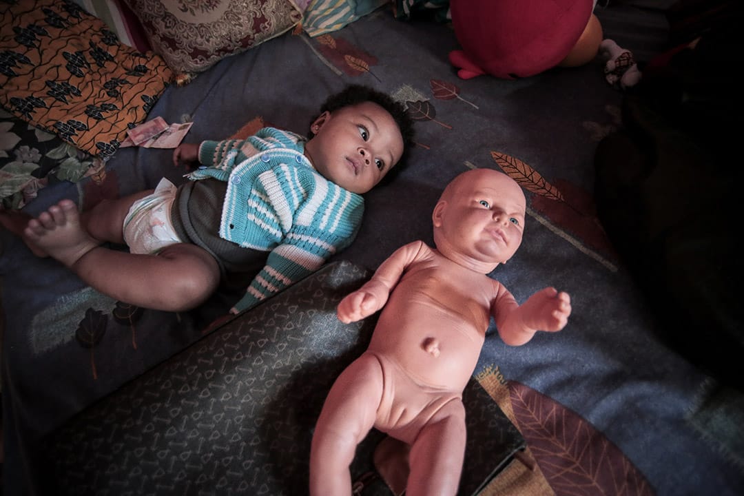 2013年，一位印尼与尼日利亚寻求庇护者的孩子，伴随着她的是一个人形娃娃。摄: Billy H.C. Kwok/ 端传媒