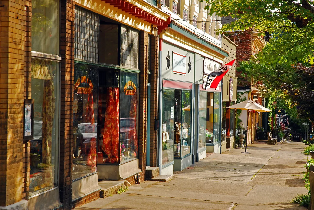 Charming small-town main street with antique shops and local storefronts, showcasing traditional retail and community-focused commerce.