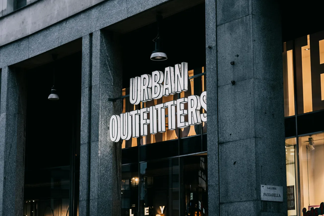 Signage of Urban Outfitters on a modern, gray stone building.