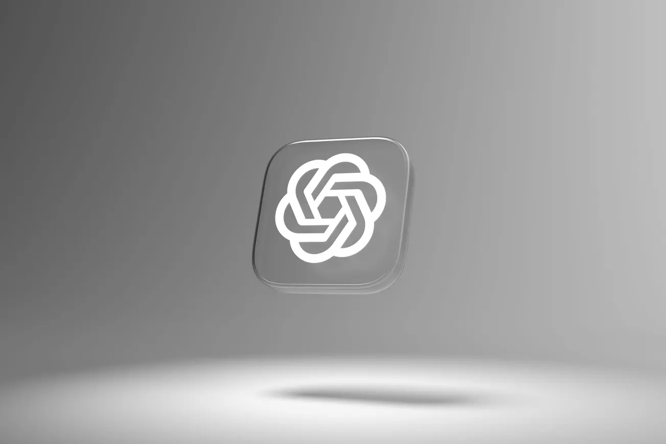 Floating translucent square with a white geometric knot logo on a grey gradient background. The scene conveys a modern, sleek, and minimalist feel.