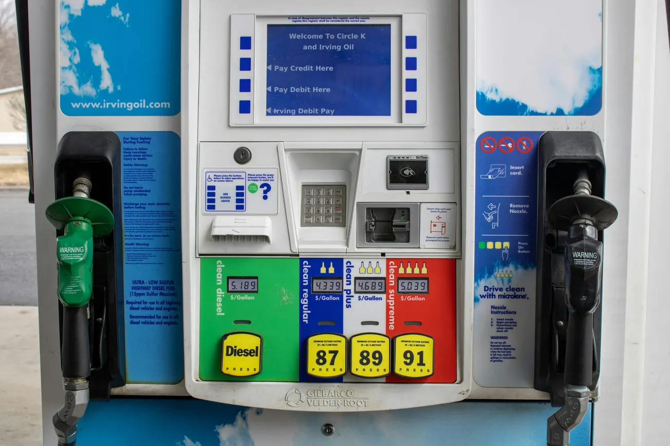 Gas station pump with diesel and three gasoline options: 87, 89, 91 octane. Displays prices per gallon. Keypad and card payment slots are visible.