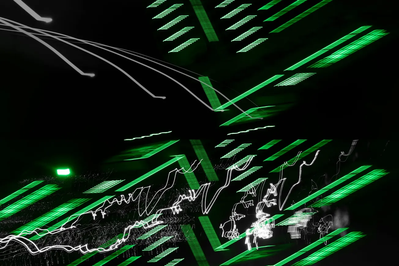 Abstract light trails in green and white create dynamic, zigzag patterns against a black background, evoking a sense of speed and energy.