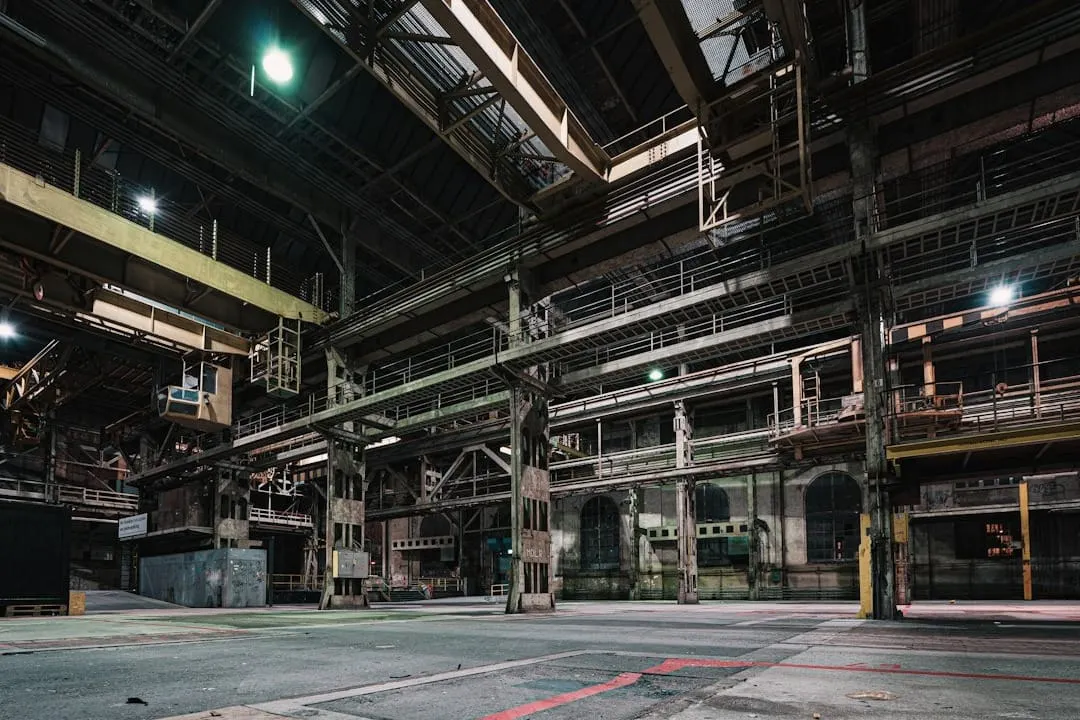 Steel beams move through a modern fabrication facility, illustrating the robust manufacturing sector and interconnected North American supply chain.