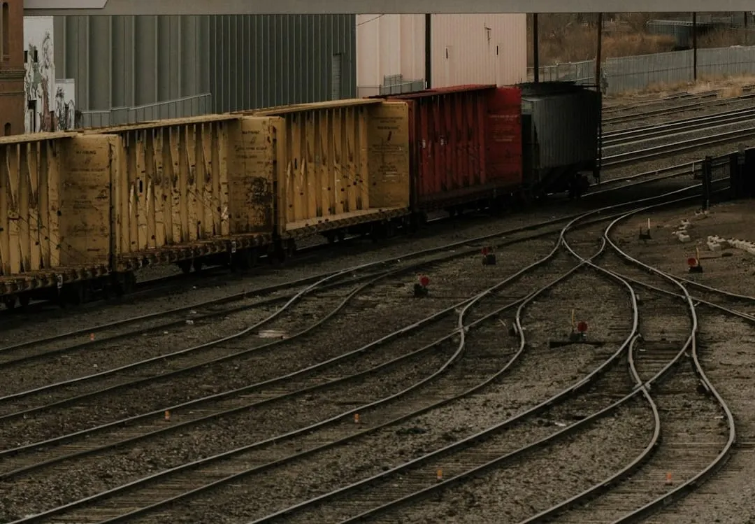A sleek, long freight train moves efficiently on tracks through a digital landscape, symbolizing enhanced data transparency in modern rail supply chain logistics.