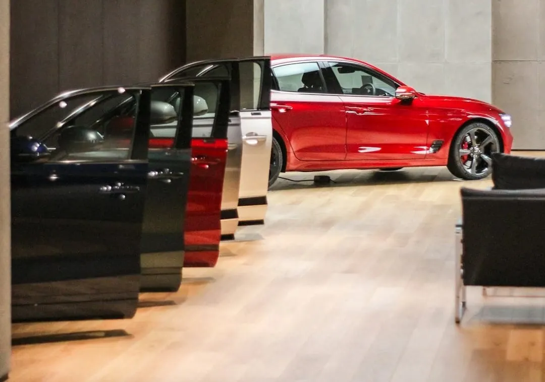 A sleek, modern automotive "playground" interior features interactive digital displays and comfortable seating areas, showcasing a new vehicle for an immersive omnichannel retail experience.