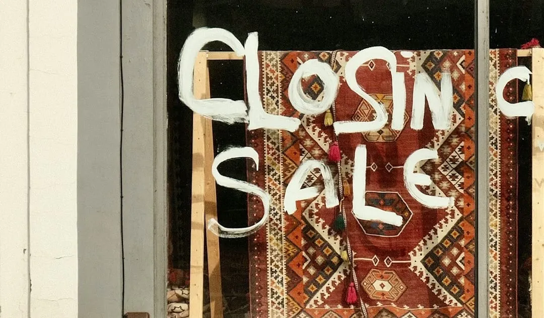 An empty retail storefront with a 'Closing Sale' banner symbolizes the critical challenges brick-and-mortar retailers face against rapid e-commerce expansion.