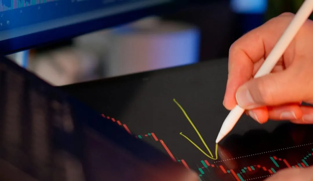 A focused individual observes dynamic stock market charts on a tablet screen, symbolizing the integration of artificial intelligence in investment strategy.