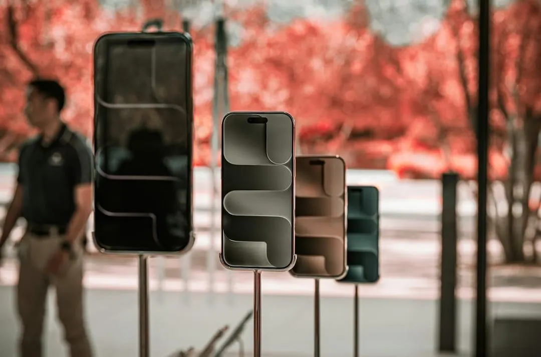 Consumers utilize their mobile devices to compare deals from different retailers, showcasing modern omnichannel shopping behaviors during a major sales event.
