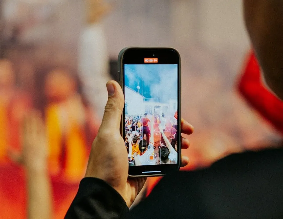 Soccer fans capture a moment of a brand's creative, unofficial World Cup marketing, highlighting evolving omnichannel engagement strategies in sports.