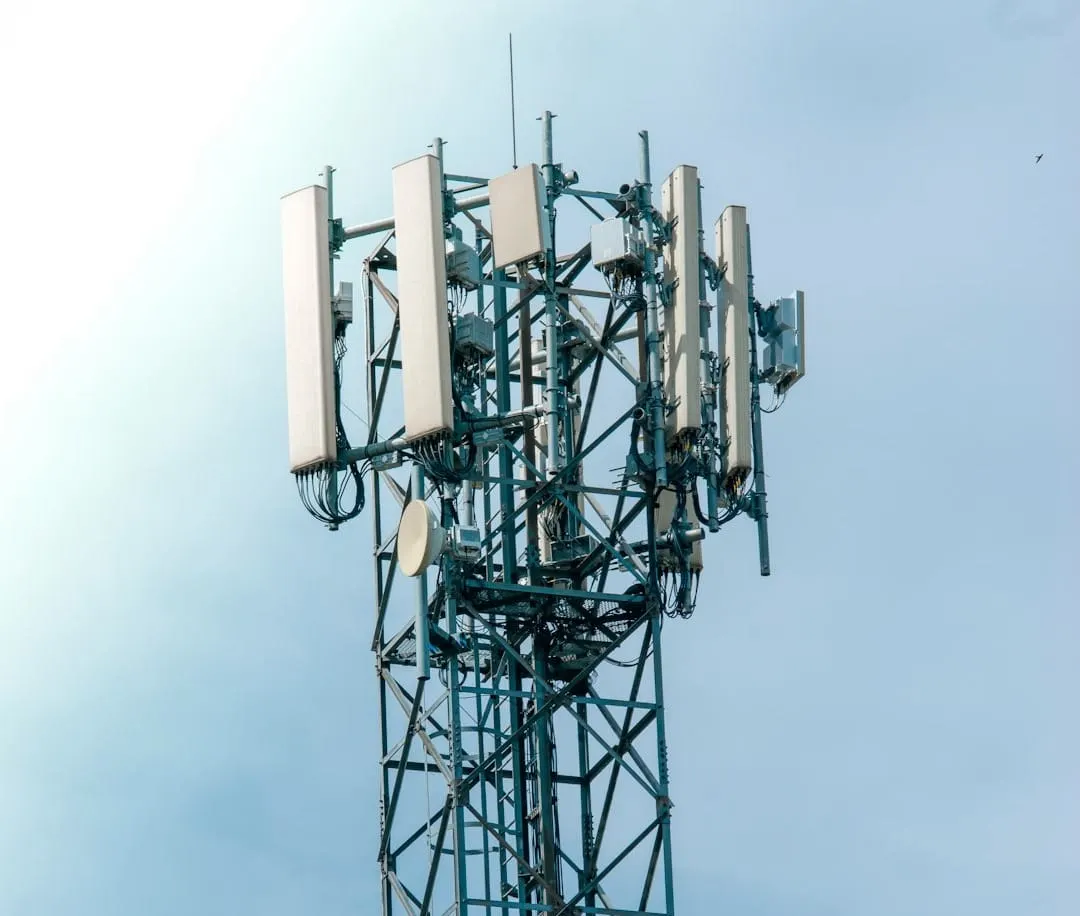 A futuristic network tower extends skyward, symbolizing strategic telecommunications growth and market consolidation amidst industry shifts.