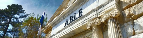 A classic grecian style bank with ABLE carved into its facade.
