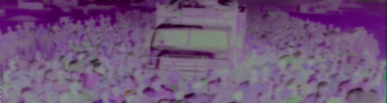 Food truck surrounded by large crowd