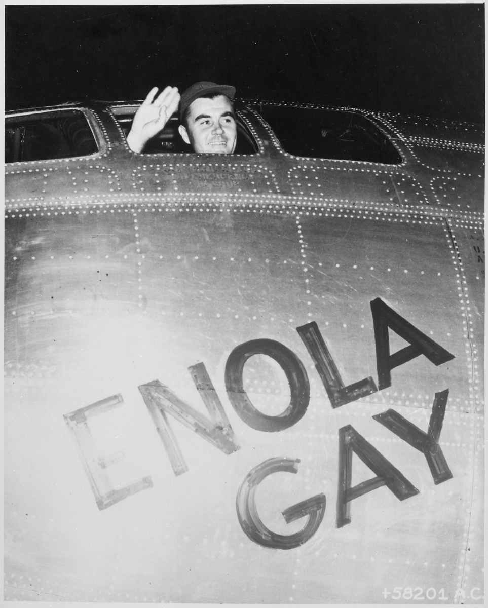 Col. Paul Tibbets, Jr., waves from the cockpit of the Enola Gay before departing for Hiroshima, August 6, 1945. National Archives Identifier 535737]