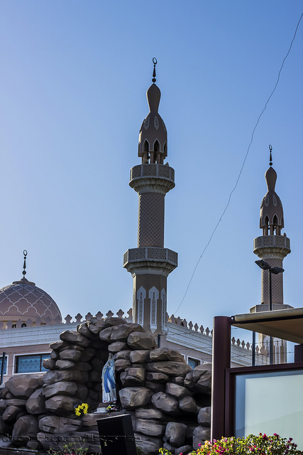 The parish's Marian grotto, with a mosque in the background / jay tornaquia / Flickr