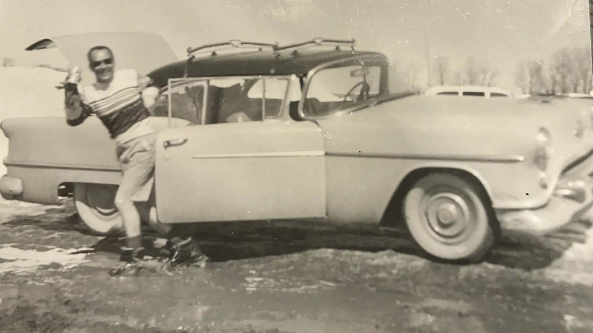 Skier in front of 1954 Oldsmobile