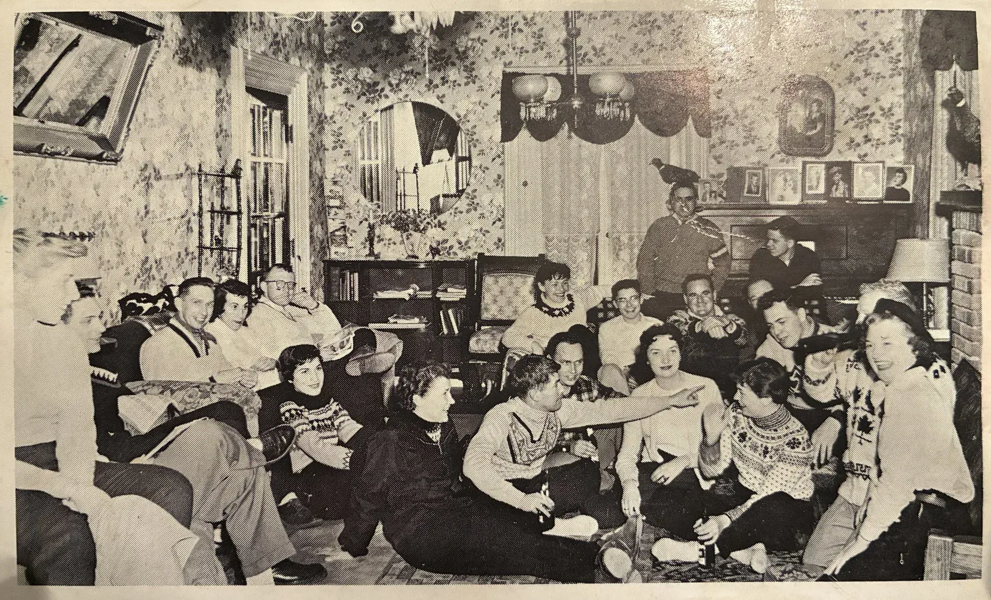 Postcard front: Young skiers gather in the parlor at Ma McGees