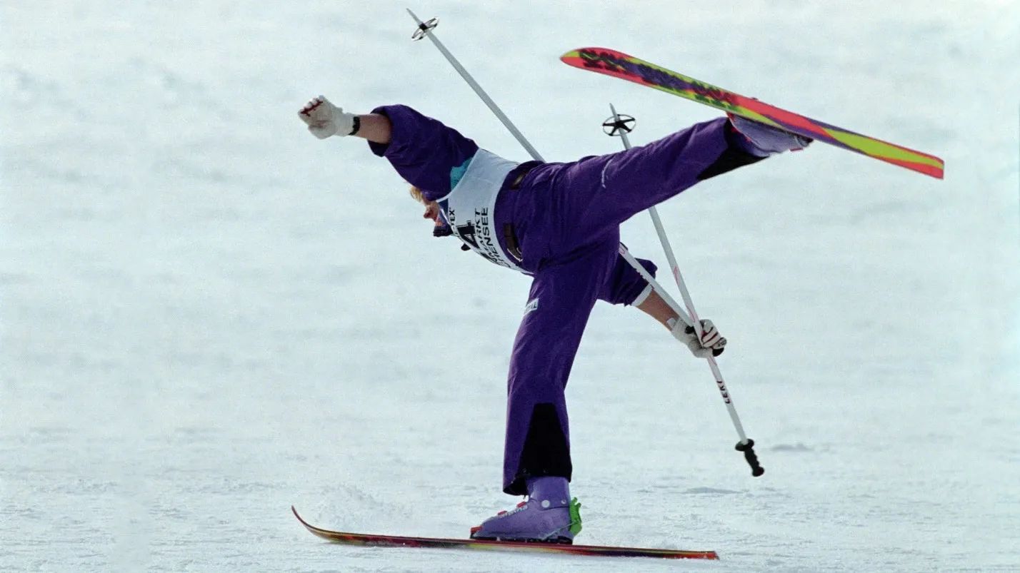 Althlete performs a ski ballet competition move on 1 ski