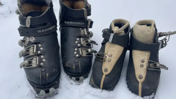 A pair of old leather ski boots circa 1960s in the snow