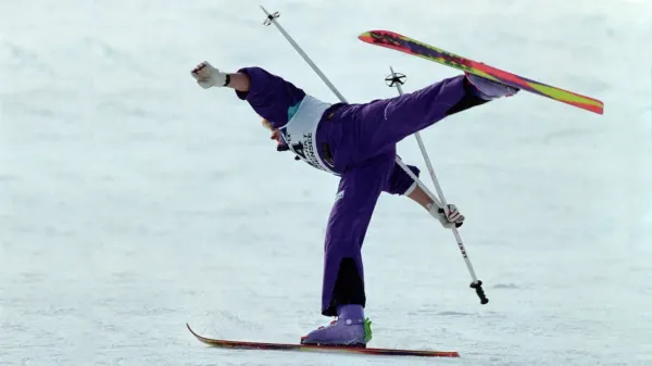Althlete performs a ski ballet competition move on 1 ski