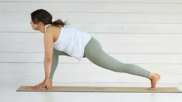 Woman stretches in a forward lunge