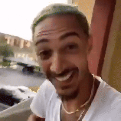 [Image alt-text: A man smiling and laughing pretending like he’s gonna jump from a balcony, drink bleach and set himself on fire]